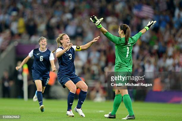 Hope Solo, Amy LePeilbet and Christie Rampone of the United States celebrate after defeating Japan by a score of 2-1 to win the Women's Football gold...