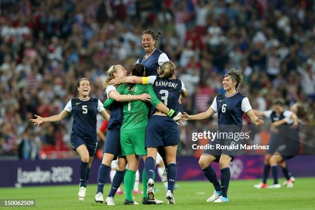 Hope Solo, Shannon Boxx and Christie Rampone, Amy LePeilbet, Kelley O'Hara of the United States celebrates after defeating Japan by a score of 2-1 to...