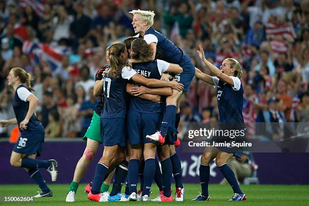 Megan Rapinoe, Heather Mitts and the United States women's soccer team celebrate after defeating Japan by a score of 2-1 to win the Women's Football...