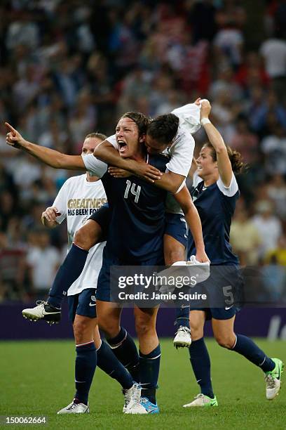 Shannon Boxx jumps on the back of Abby Wambach of the United States after defeating Japan by a score of 2-1 to win the Women's Football gold medal...