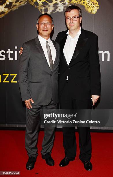 Johnny To and Olivier Pere walk the red carpet at the Life Achievement Award to Johnny To ceremony during the 65th Locarno Film Festival on August 9,...