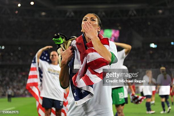 Hope Solo of the United States celebrates with the American flag after defeating Japan by a score of 2-1 to win the Women's Football gold medal match...