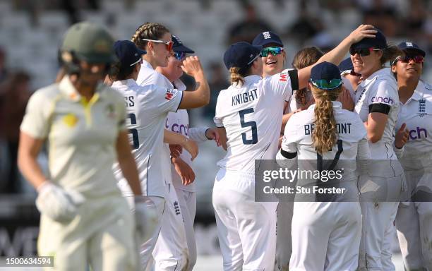 England fielder Natalie Sciver-Brunt is congratulated by team mates after catching out Australia batter Ellyse Perry for 99 runs off the bowling of...