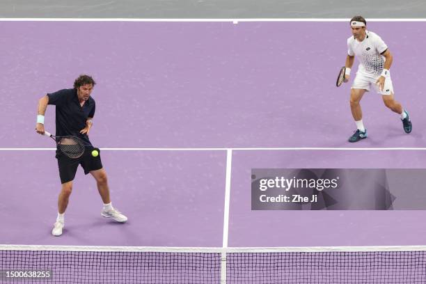 Marat Safin of Russia and David Ferrer of Spain return a shot against Carlos Moya of Spain and Juan Martin Del Potro of Argentina on Day 1 of...