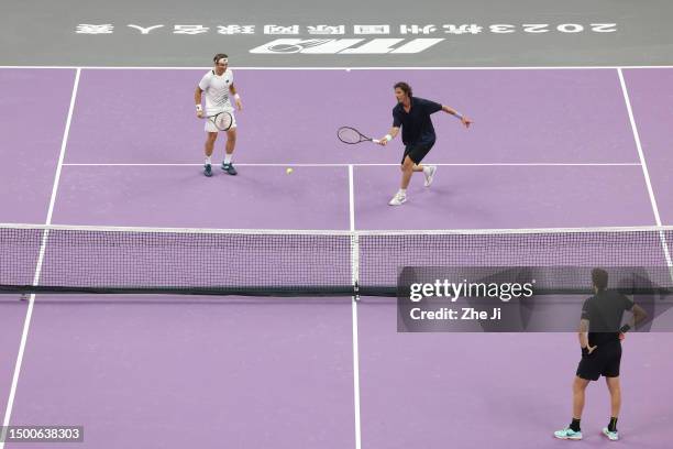 Marat Safin of Russia and David Ferrer of Spain return a shot against Carlos Moya of Spain and Juan Martin Del Potro of Argentina on Day 1 of...