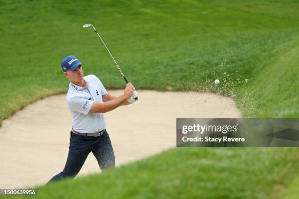 Kevin Streelman of the United States plays a shot from a bunker on the 11th hole during the first round of the Travelers Championship at TPC River...