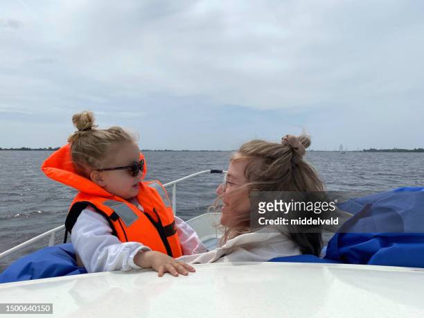 mother with toddler daughter on deck - friesland noord holland imagens e fotografias de stock