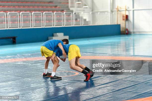 two wrestling children using new techniques - wrestling ring stock pictures, royalty-free photos & images