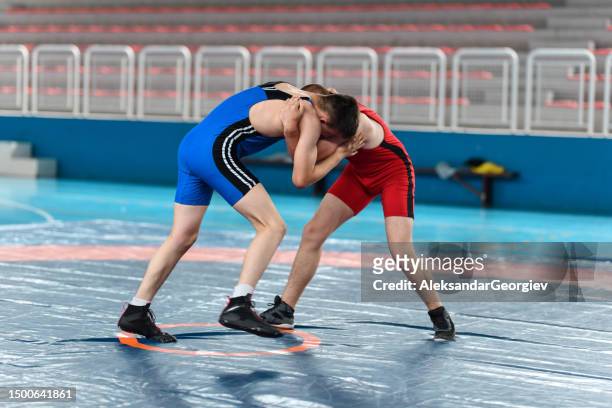 hand fighting by two wrestlers trying to gain dominant position during match - wrestling team stock pictures, royalty-free photos & images