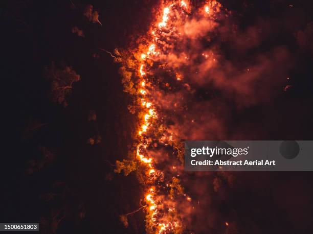 wildfire burning at night photographed from a drone point of view, alice springs, northern territory, australia - australia bushfire stock pictures, royalty-free photos & images