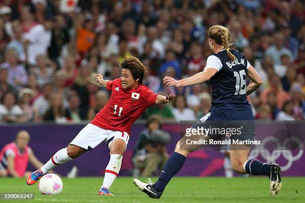 Shinobu Ohno of Japan kicks the ball past Rachel Buehler of United States in the second half during the Women's Football gold medal match on Day 13...