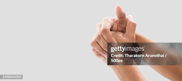 a man cracking their knuckles,bangkok,thailand - knuckle ストックフォトと画像