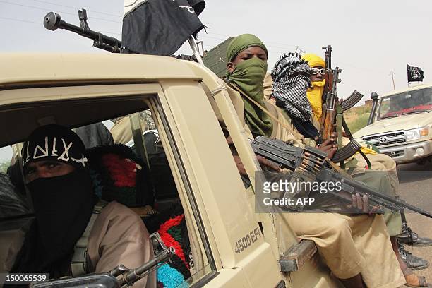 Photo taken on August 7, 2012 shows fighters of the Islamic group Ansar Dine standing guard at the Kidal Airport in northern Mali. Mali's government...