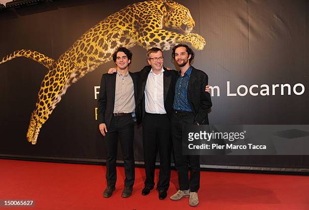 Filmmakers Benny Safdie and Josh Safdie pose with Olivier Pere on the red carpet at the Life Achievement Award to Johnny To ceremony during the 65th...