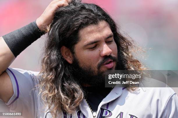 Jorge Alfaro of the Colorado Rockies stands in the dugout during a