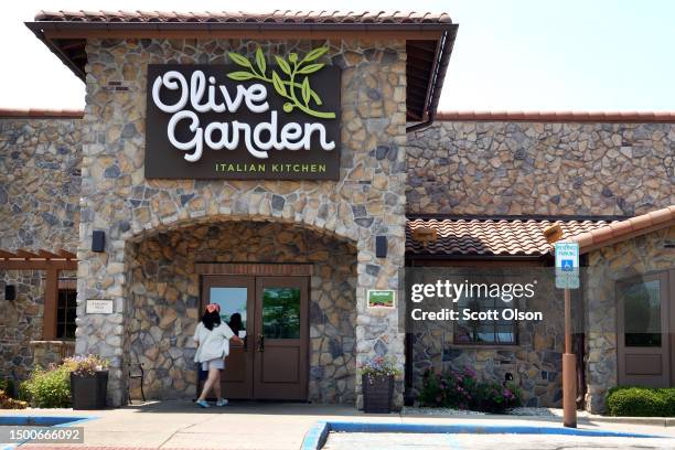 Sign hangs on the front of an Olive Garden restaurant on June 22, 2023 in Chicago, Illinois. Darden Restaurants, the parent company of Olive Garden,...