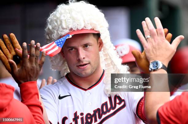 Riley Adams of the Washington Nationals celebrates with teammates after hitting a two-run home run in the ninth inning against the Arizona...