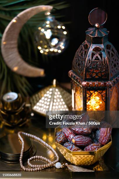 close-up of illuminated lantern on table - iftar stock pictures, royalty-free photos & images