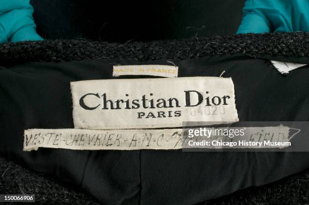 Designer label from women's suit, 1948. By Christian Dior. Christian Dior named this suit 'Chevrier,' which he translated as 'shepherdess.' The raw,...