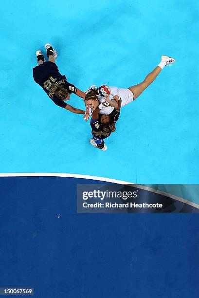 Katarina Bulatovic of Montenegro scores despite the attention from Begona Fernandez Molinos and Marta Mangue Gonzalez of Spain during the Women's...