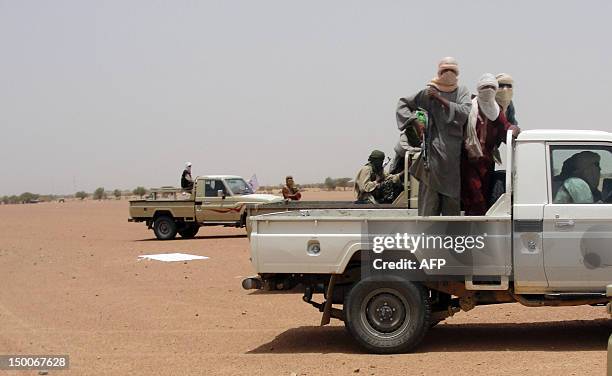 Photo taken on August 7, 2012 shows figthers of the Islamic group Ansar Dine standing in pick-up trucks in Kidal, northern Mali. Mali's government...