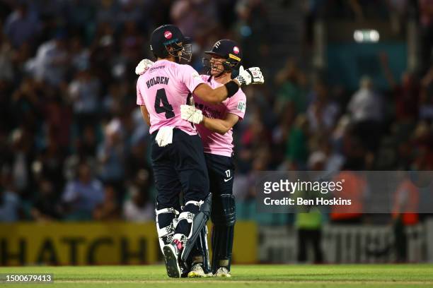 Jack Davies of Middlesex celebrates with team mate Max Holden after hitting the winning runs in Middlesex's record break chase of 254 in the Vitality...