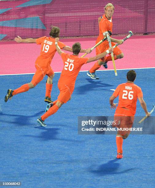Netherlands' captain Floris Evers celebrates with teammates Sander de Wijn, Bob de Voogd and Valentin Verga after a goal against Great Britain during...