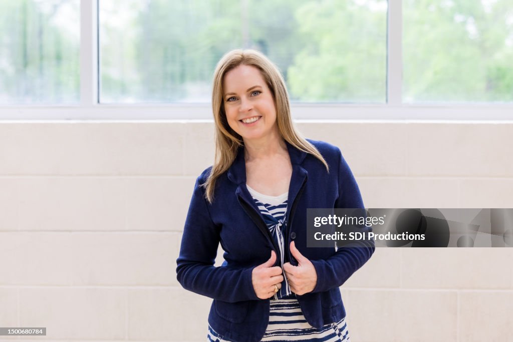 Portrait mature adult female teacher in school building