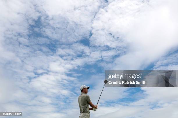 Collin Morikawa of the United States watches his shot from the third tee during the first round of the Travelers Championship at TPC River Highlands...