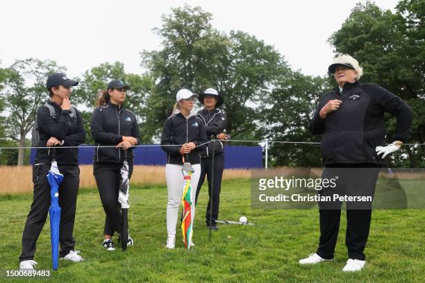 Laura Davies of England speaks with Australian professional golfer Karrie Webb during the first round of the KPMG Women's PGA Championship at...