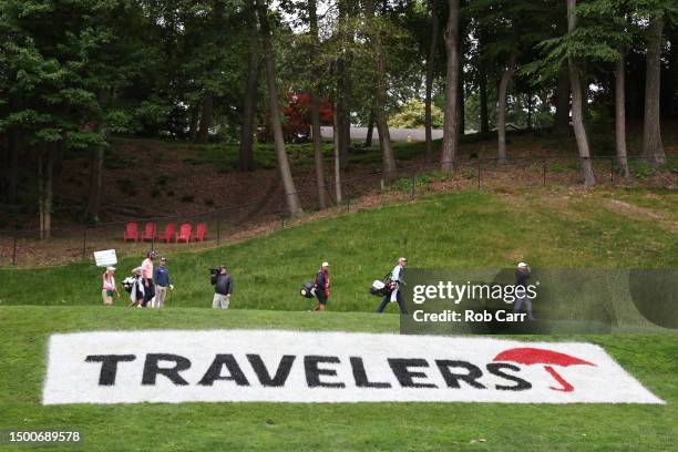 Justin Thomas of the United States, Max Homa of the United States and Wyndham Clark of the United States walk off the 15th tee during the first round...