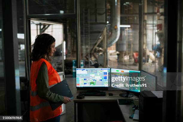 female supervisor controlling automatic production system in wood factory - kontrollrum bildbanksfoton och bilder