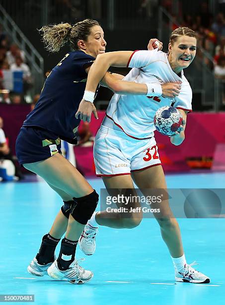 Katarina Bulatovic of Montenegro is defended by Begona Fernandez Molinos of Spain during the Women's Handball semifinal game between Spain and...