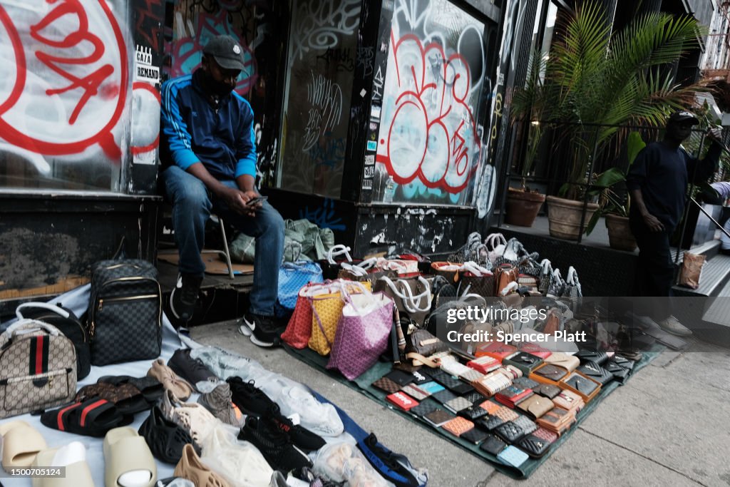 Knock-off luxury goods are displayed by sellers along a sidewalk on News  Photo - Getty Images