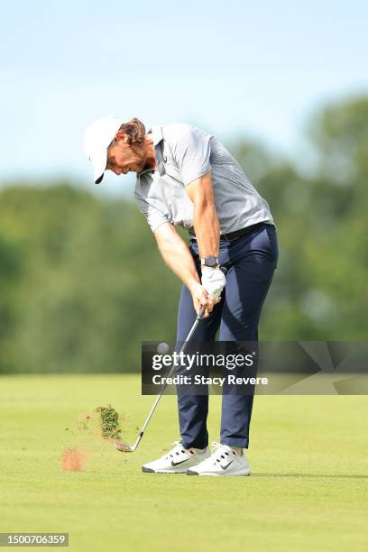 Tommy Fleetwood of England plays an approach shot on the 14th hole during the first round of the Travelers Championship at TPC River Highlands on...