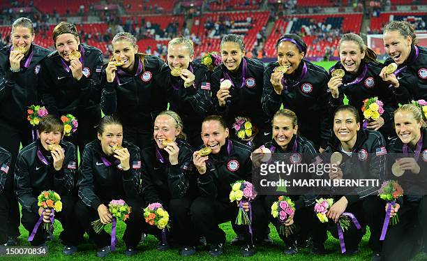 Gold medalist Team USA pose for photographers after the podium ceremony of the women's football competition of the London 2012 Olympic Games on...