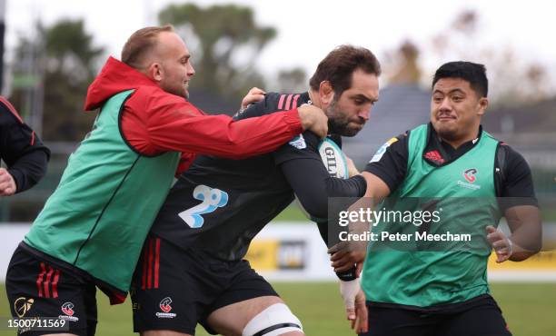 Sam Whitelock of the Crusaders drives through the tackle of Tom Christie in a game of ruck touch during a Crusaders Super Rugby captain's run at...