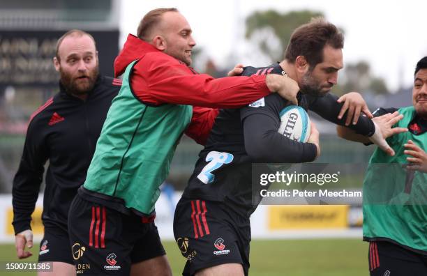 Sam Whitelock of the Crusaders drives through the tackle of Tom Christie in a game of ruck touch during a Crusaders Super Rugby captain's run at...