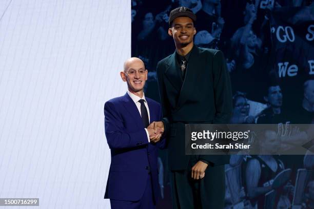 Victor Wembanyama poses with NBA commissioner Adam Silver after being drafted first overall pick by the San Antonio Spurs during the first round of...