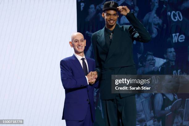 Victor Wembanyama poses with NBA commissioner Adam Silver after being drafted first overall pick by the San Antonio Spurs during the first round of...