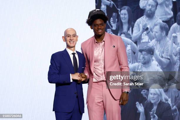 Taylor Hendricks poses with NBA commissioner Adam Silver after being drafted ninth overall pick by the Utah Jazz during the first round of the 2023...