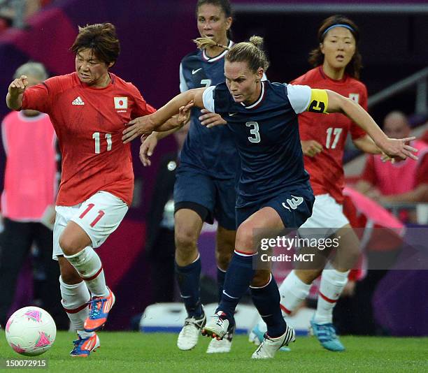 Defender Kelley O'Hara battles for the ball with Japan Shinobu Ohno during the first half of the Olympics women's soccer final at Wembley Stadium in...