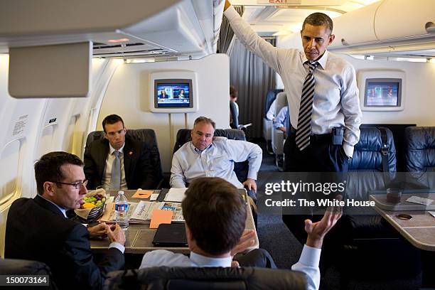 In this handout image provided by the White House, U.S. President Barack Obama listens to Sen. Mark Warner, D-Va., while Senior Advisor David...