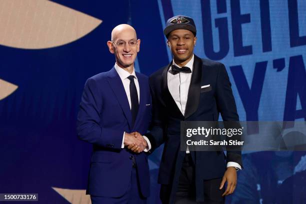 Jordan Hawkins poses with NBA commissioner Adam Silver after being drafted 14th overall pick by the New Orleans Pelicans during the first round of...