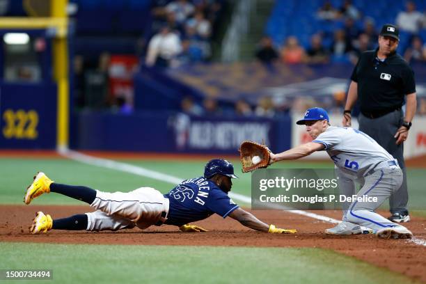 Randy Arozarena of the Tampa Bay Rays slides back to first base safely as Matt Duffy of the Kansas City Royals covers during the seventh inning at...