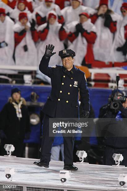 New York City Police Officer Daniel Rodriguez waves to the crowd after singing "America the Beautiful" at the start of the Opening Ceremony of the...