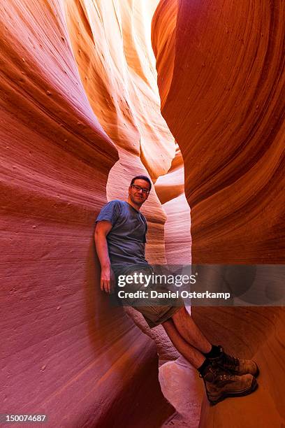 man leaning against wall - natural landmark stock-fotos und bilder