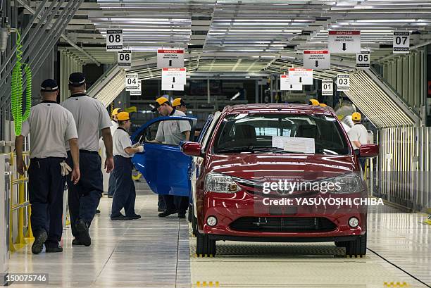 Toyota's workers are trained to examine the new compact car, ETIOS, at the new factory in Sorocaba, about 100km west of Sao Paulo, Brazil on August...