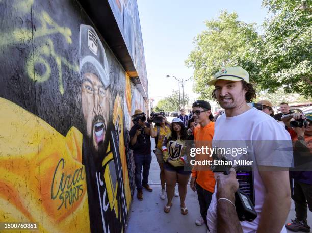 Artists Sara Godbout and Juan Ochoa and Vegas Golden Knights team captain Mark Stone look at a mural in the Downtown Las Vegas Arts District...