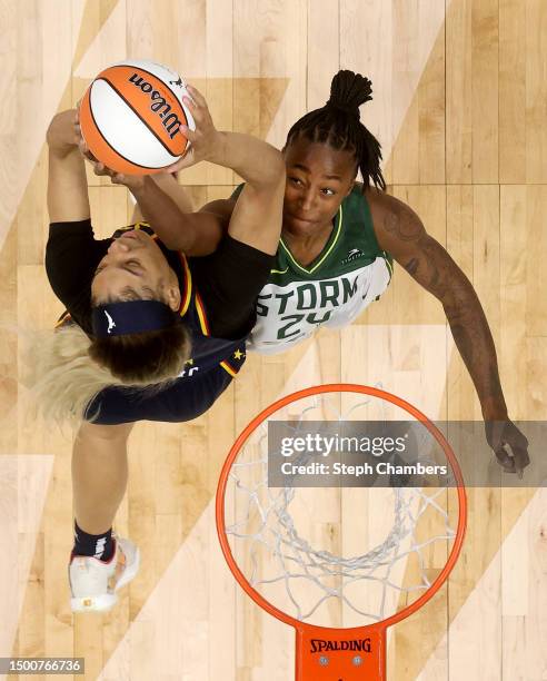 Victaria Saxton of the Indiana Fever and Jewell Loyd of the Seattle Storm rebound during the fourth quarter at Climate Pledge Arena on June 22, 2023...